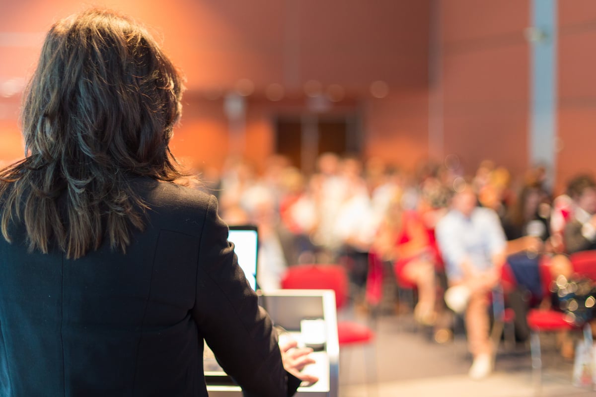 Business Woman Lecturing at Conference